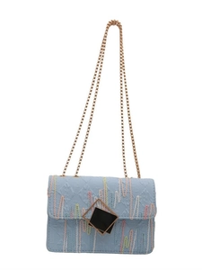 Light blue crossbody chain bag with colorful wave embroidery and geometric gold buckle