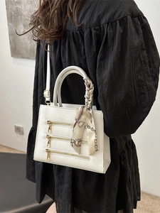 Chic white square crossbody bag with zipper detail and decorative handle silk scarf