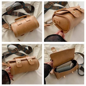 Detailed view of cylindrical crossbody bag interior showing storage for cosmetics