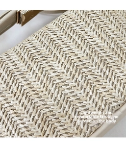 Macro shot of straw woven crossbody bag featuring beige texture and golden metal buckle