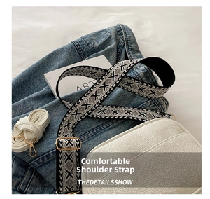 Detail of cream white pebbled leather bag with geometric jacquard wide shoulder strap