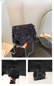 Detail showing high-gloss black sequins and silver metal chain strap on square bag
