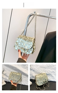 Detail view of gold sequin crossbody evening bag with woven metal chain strap for women