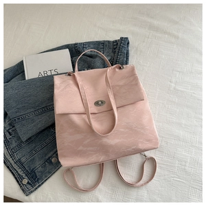 Detailed close-up of marble pattern on pink leather bag with silver turn-lock closure
