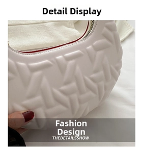 Macro detail of white leather shoulder bag featuring geometric embossed texture and red lining