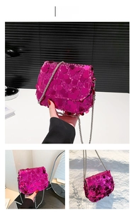 Detail of magenta large sequin crossbody bag with silver metal chain strap