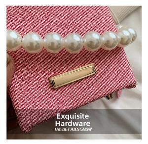 Macro shot of red woven texture with white pearl strap and golden metal buckle