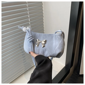 Detailed view of light blue marble textured handbag featuring a silver metal bow buckle