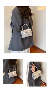 Detail of silver metallic PU leather mini bag with a 3D bow and adjustable shoulder strap