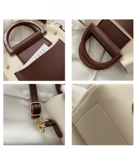 Detail view of contrast color tote bag with resin handles and golden metal rivets