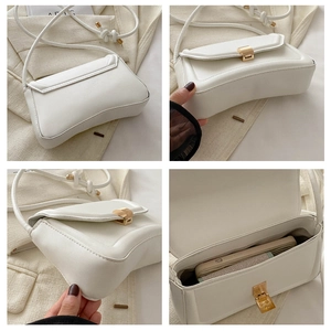 Macro detail of white PU leather crossbody bag with light gold buckle and interior storage