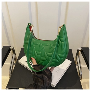 Detail of green crescent shoulder bag with geometric quilting and gold zipper