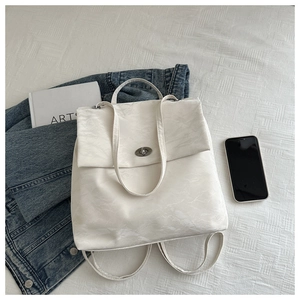 Detail of white marble pattern backpack with silver metal twist lock and thin straps