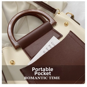 Detail of portable insert pocket on a two-tone faux leather tote bag with gold rivets