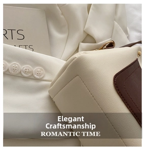 Detailed view of precision stitching and leather texture on a beige and brown tote bag