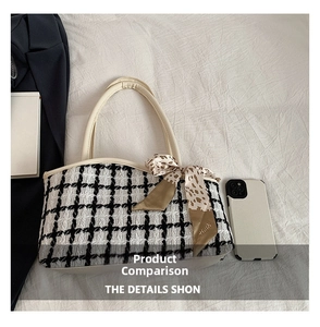 Detail of black and white checkered tote bag with leopard print silk scarf on white fabric