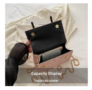 Detail view of pink crossbody bag interior with dual magnetic clasps and phone storage