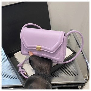 Detail of lavender saddle bag with golden metal buckle and premium stitching texture