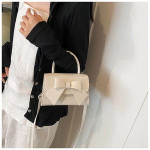 Fashion cream white bow handbag with glossy leather texture and detachable strap details