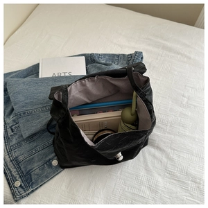 Interior view of large black pleated leather bag showing spacious capacity for daily items
