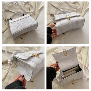 Detail view of white stone pattern small square bag with golden buckle and textured finish