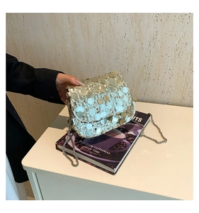 Detail of silver sequin crossbody bag with chain strap for party or evening events
