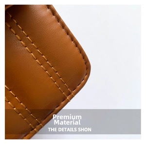 Detail of dark brown leather texture with precise double yellow parallel stitching