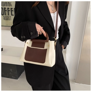 Retro cream and brown contrast handbag with wooden handle shown on a model
