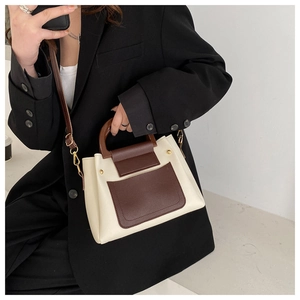 Detail of retro small square bag with beige leather and dark brown contrast stitching