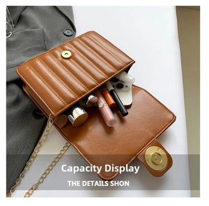 Detail view of brown quilted leather bag interior showing storage capacity and gold chain