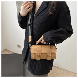 Chic tan cylinder crossbody bag with golden hardware and ethnic geometric wide strap