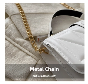 Detailed shot of white quilted shoulder bag with premium chunky gold chain strap
