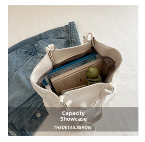 Top view of large white tote bag interior showing ample space for books and umbrella