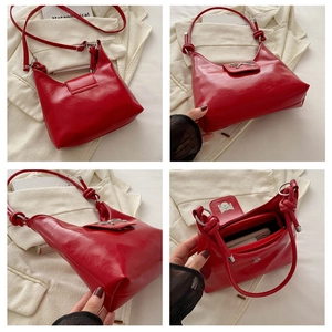 Detail of red patent leather shoulder bag with silver bow accent and knot strap