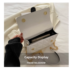 Macro view of white quilted chain bag showing spacious interior for a large smartphone