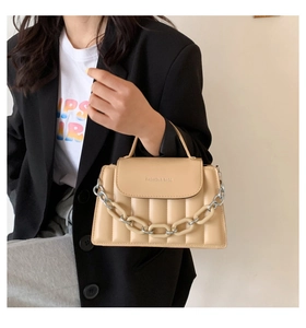 Detail of cream quilted crossbody bag with chunky chain and Fashion & Bags logo