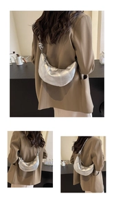 Three-angle view of a metallic silver crescent bag with knotted strap and quilted texture