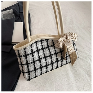 Detail of checkered woven chain tote bag with a leopard print silk scarf on handle