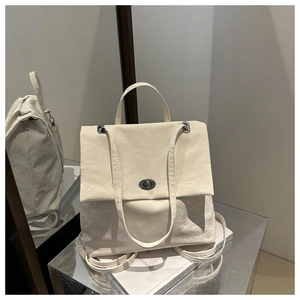 Detail of soft cream chain hobo bag showing textured leather and silver metal twist lock