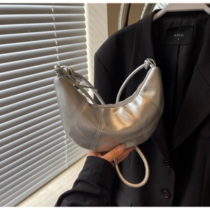 Silver metallic croissant shoulder bag with contrast stitching and crescent moon shape
