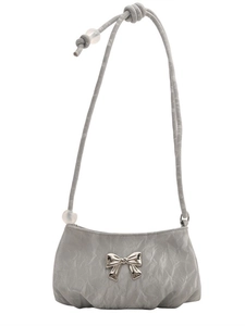Off-white pleated crossbody bag with a silver metal bow accent and bead strap detail