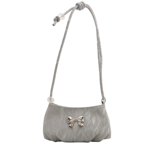 Gray mini shoulder bag with silver bow accent and ruffled texture on white background