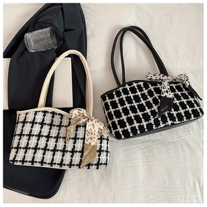 Detail of tweed tote bags with chain straps and leopard print silk scarf accessories