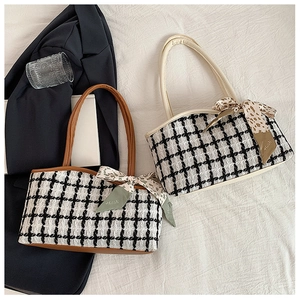 Detail of tweed tote bags with chain straps and printed scarves in a commuter setting