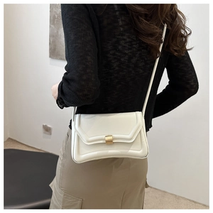 Chic white rectangular saddle bag with gold metal buckle shown on a model's shoulder