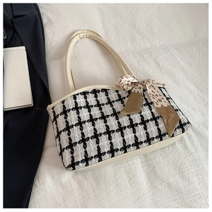 Detail of checkered tweed chain tote bag with leather base and silk scarf accessory