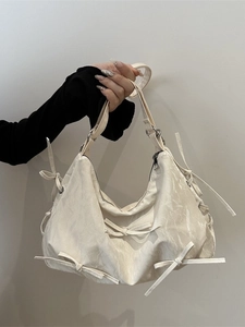 Chic beige bow-knot shoulder bag with pleated texture and silver zipper detail
