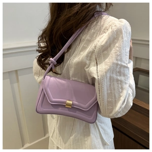 Detail of lavender saddle bag showing the gold metal buckle and knotted strap detail