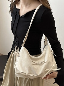 Chic cream bow shoulder bag with pleated texture for women, stylish summer crossbody purse