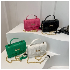 Detail of quilted leather crossbody bags with V-pattern stitching and gold metal locks